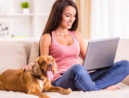 Woman with pet using laptop