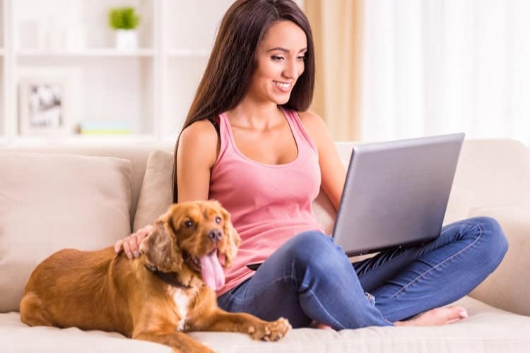 Woman with pet using laptop
