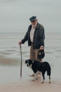 Man with cane and dog