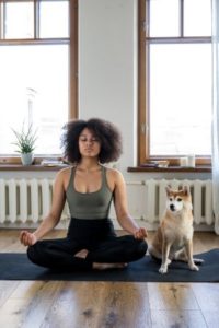 woman and dog meditating