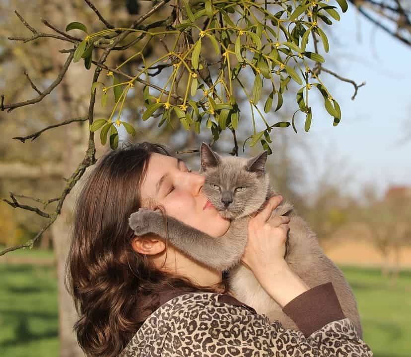 woman kissing her pet cat