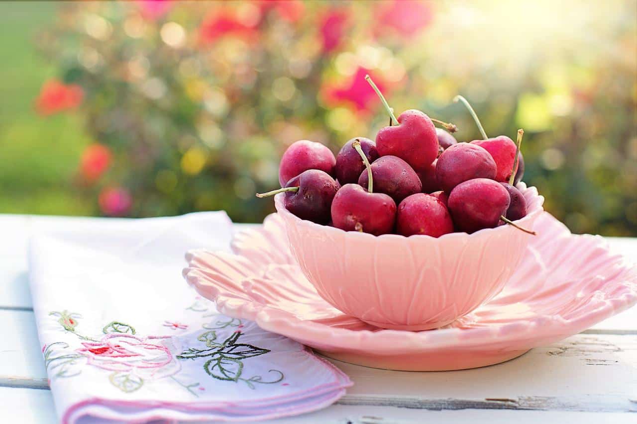 cherries in a pink bowl